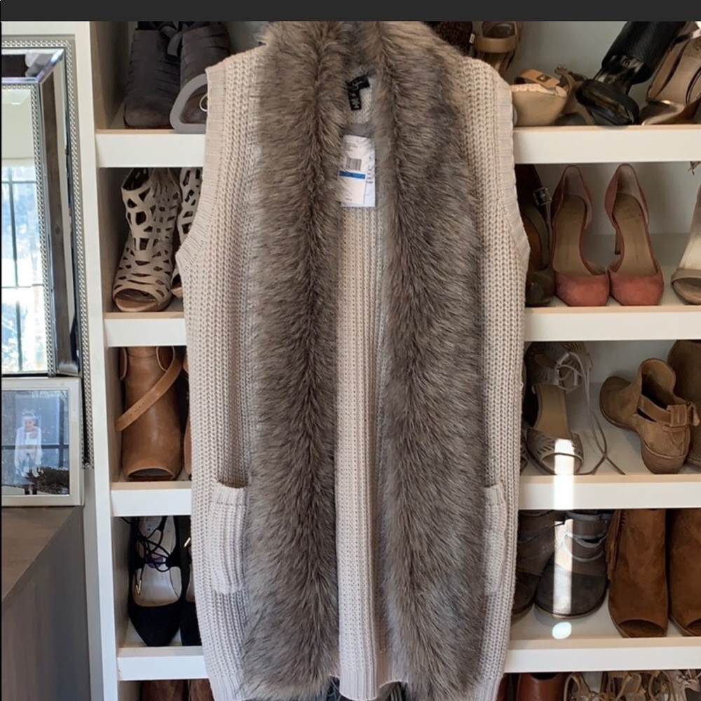 Beige faux fur vest.